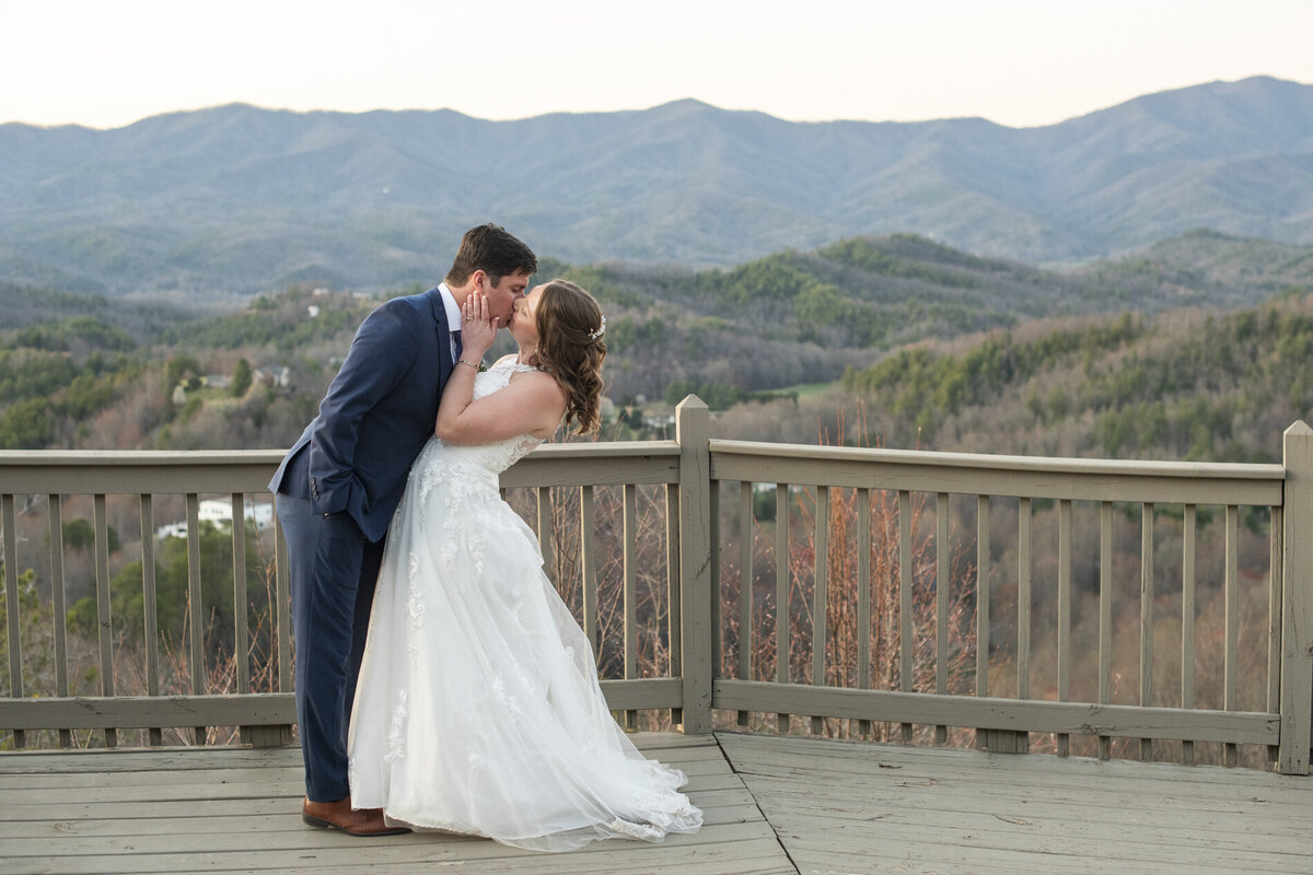 Couple kissing on mountain top during Hawkesdene wedding photos