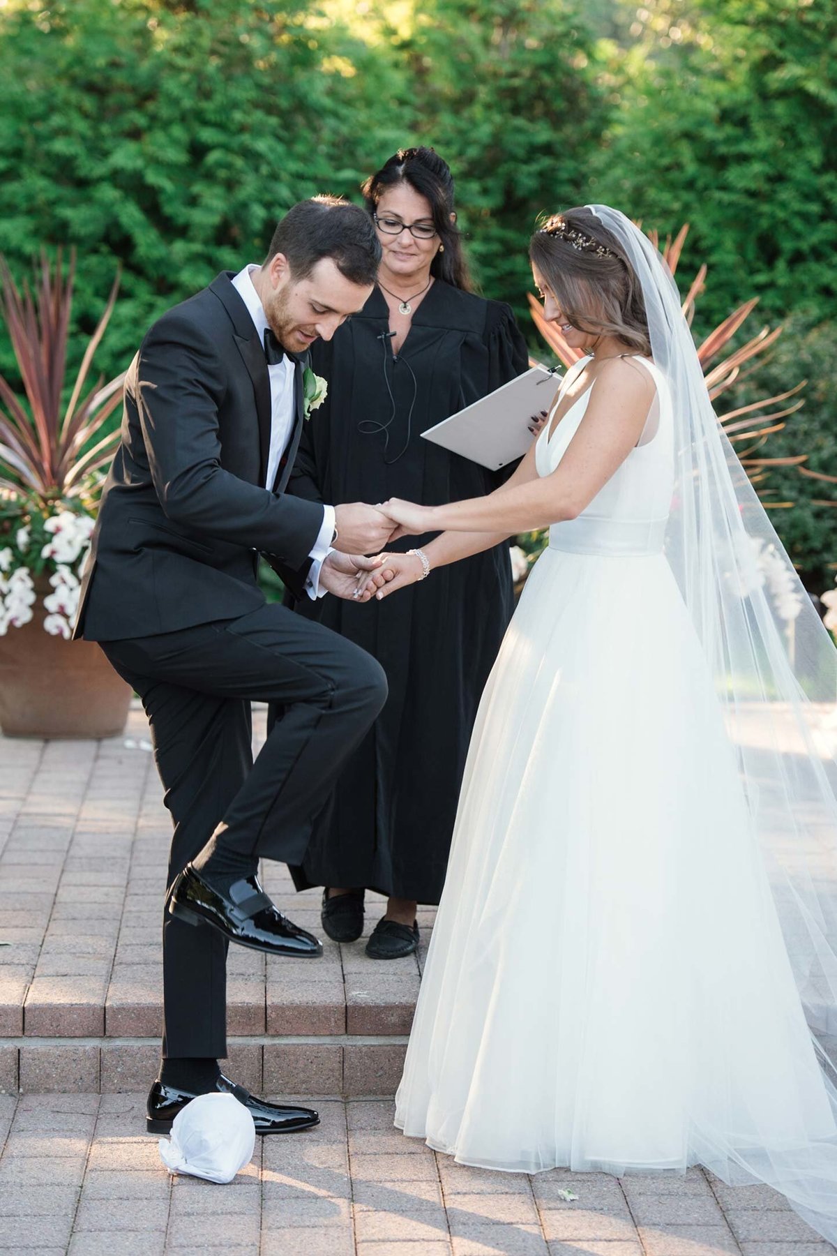 Groom stepping on glass at altar at Stonebridge Country Club