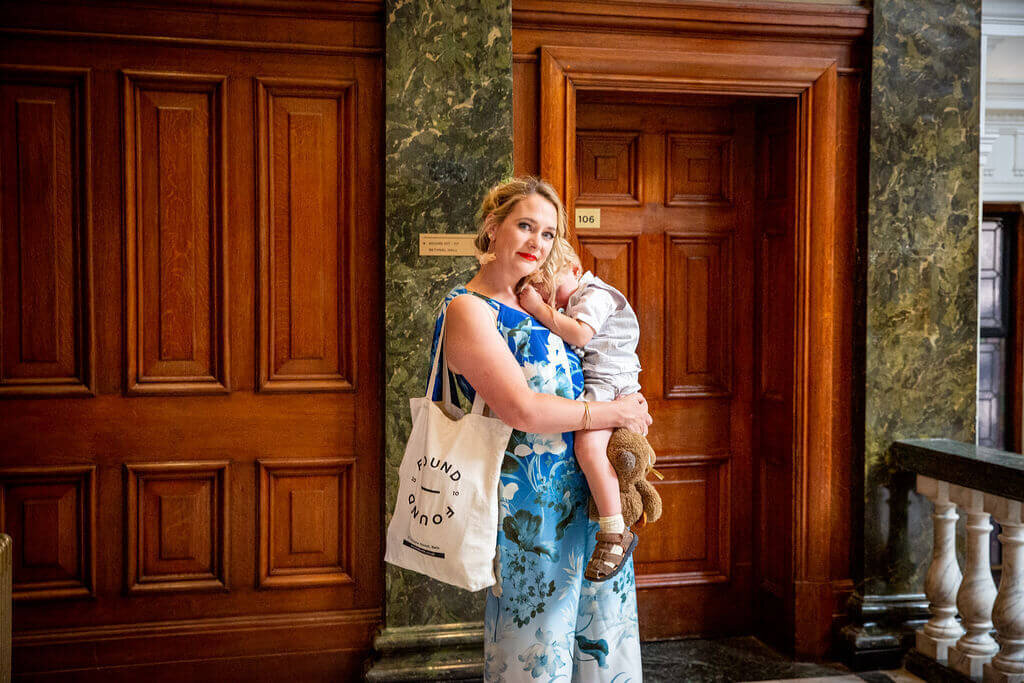 Wedding guest holding child .  Town Hall Hotel London
