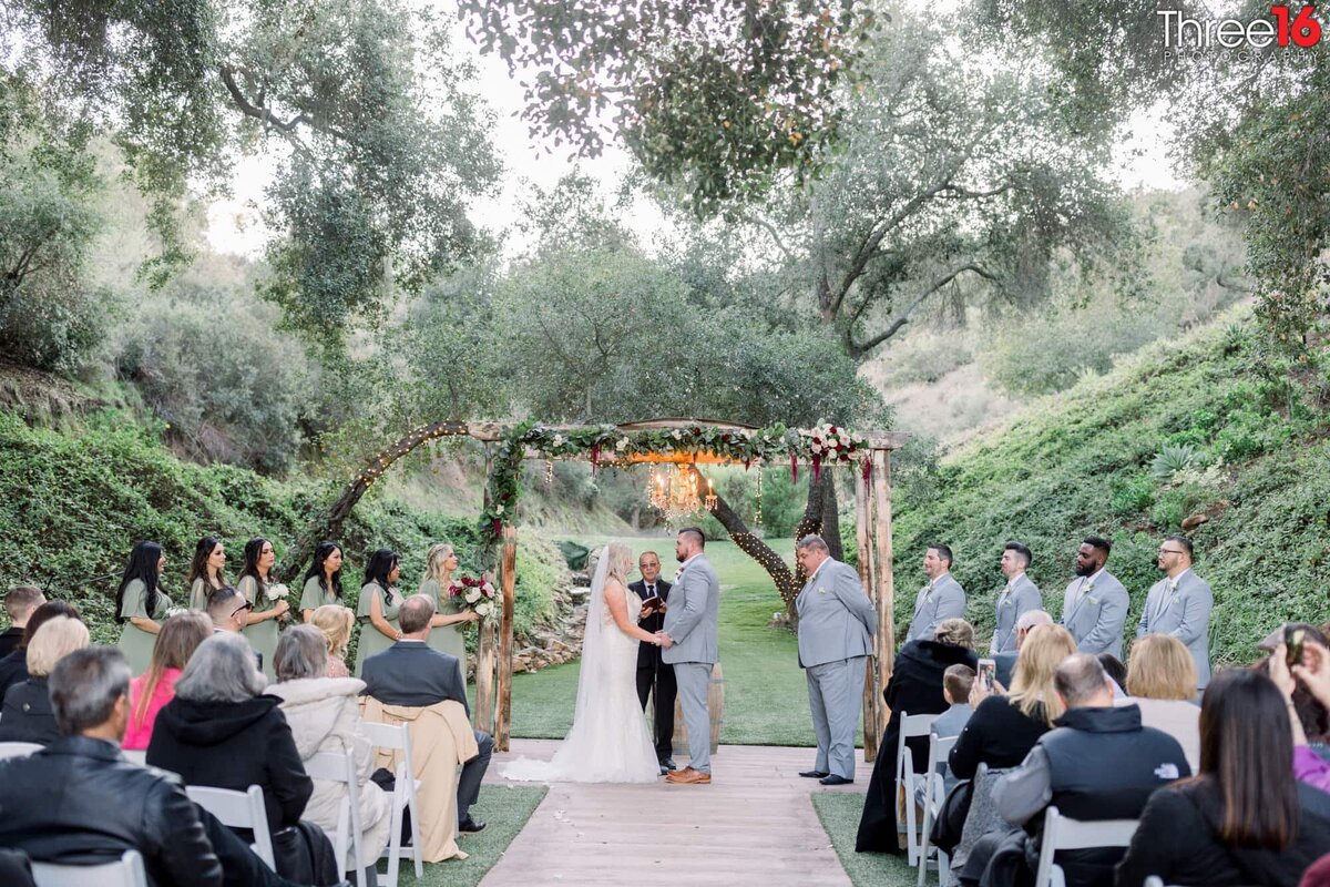 Bride and Groom face each other at the outdoor altar at Los Willows Wedding Estate