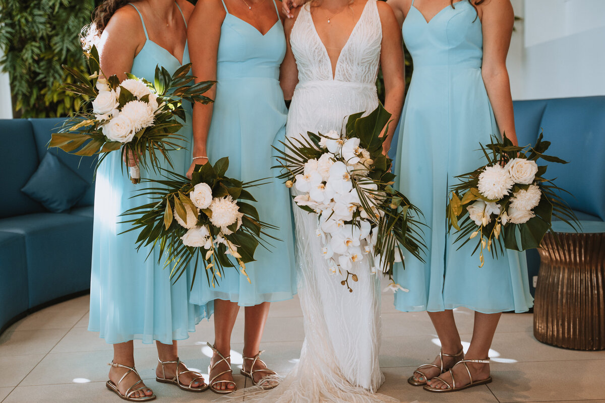bridesmaid flowers with palm leaves and orchids