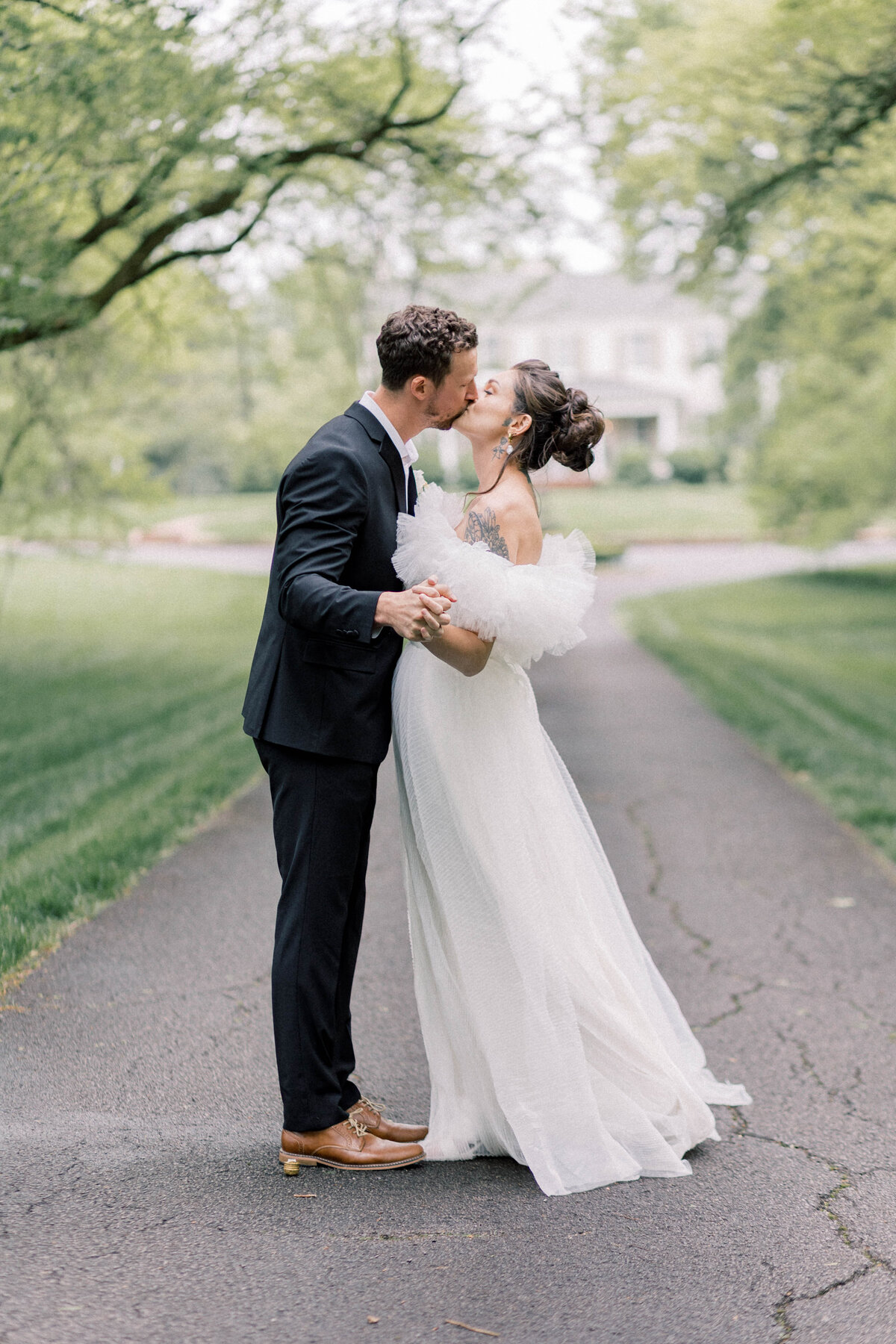 maple grove estate wedding with bride and groom kissing in front of the estate