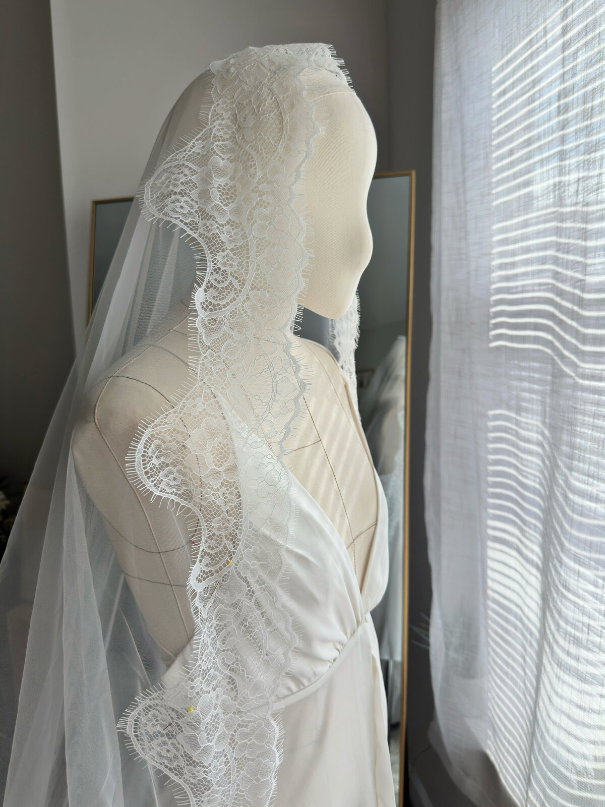 Classic Spanish-style mantilla veil with intricate floral lace trim
