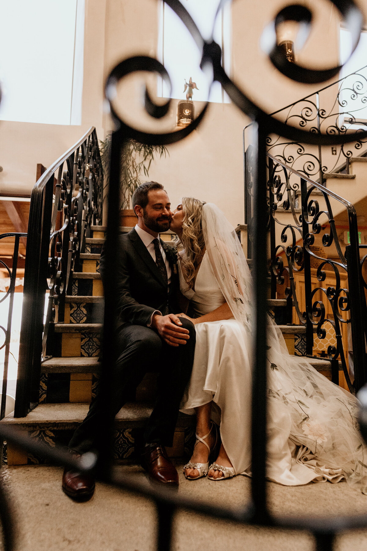 bride and groom sitting on a staircase together