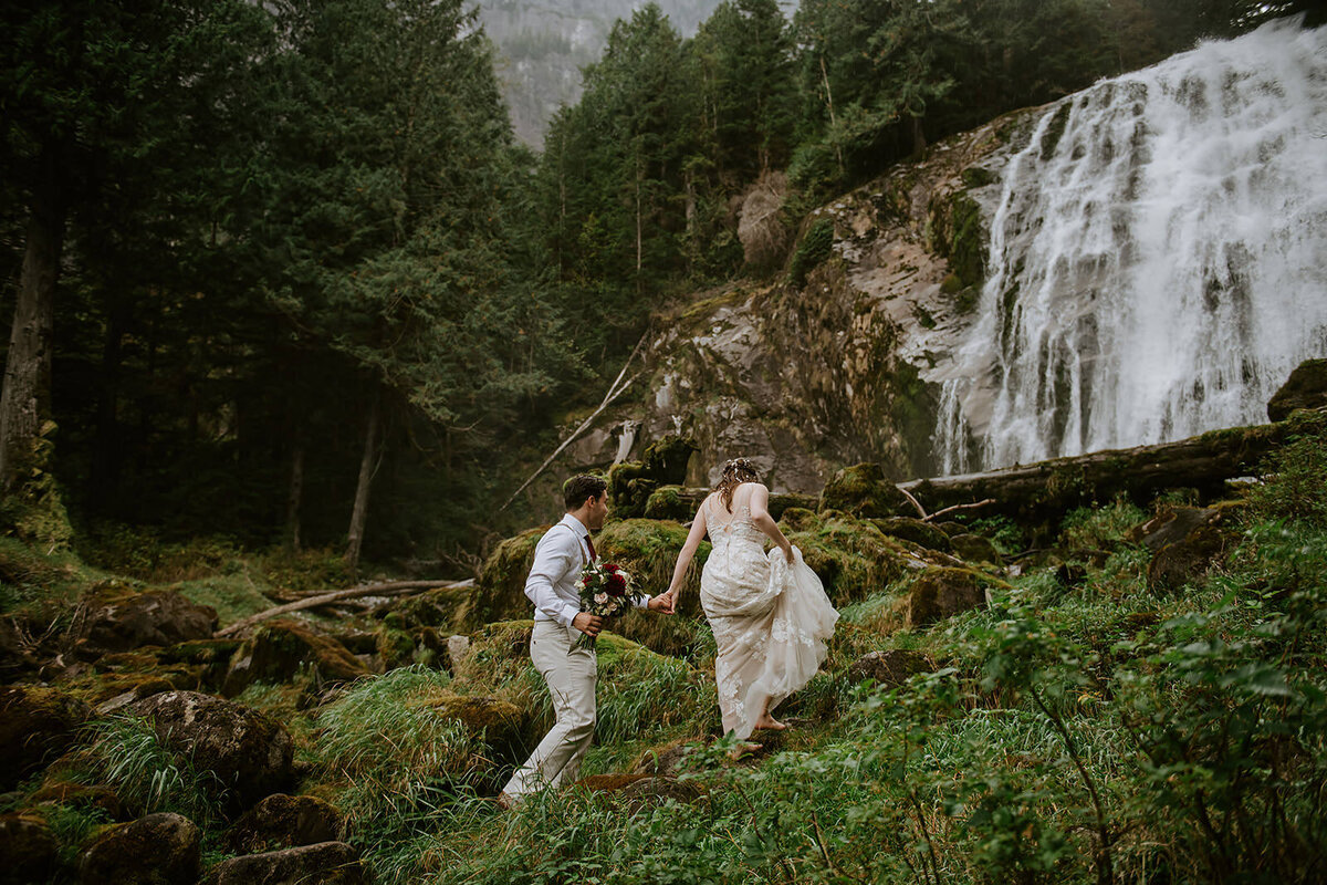 Couple during their ceremony under a waterfall during their Sunshine Coast B.C Elopement