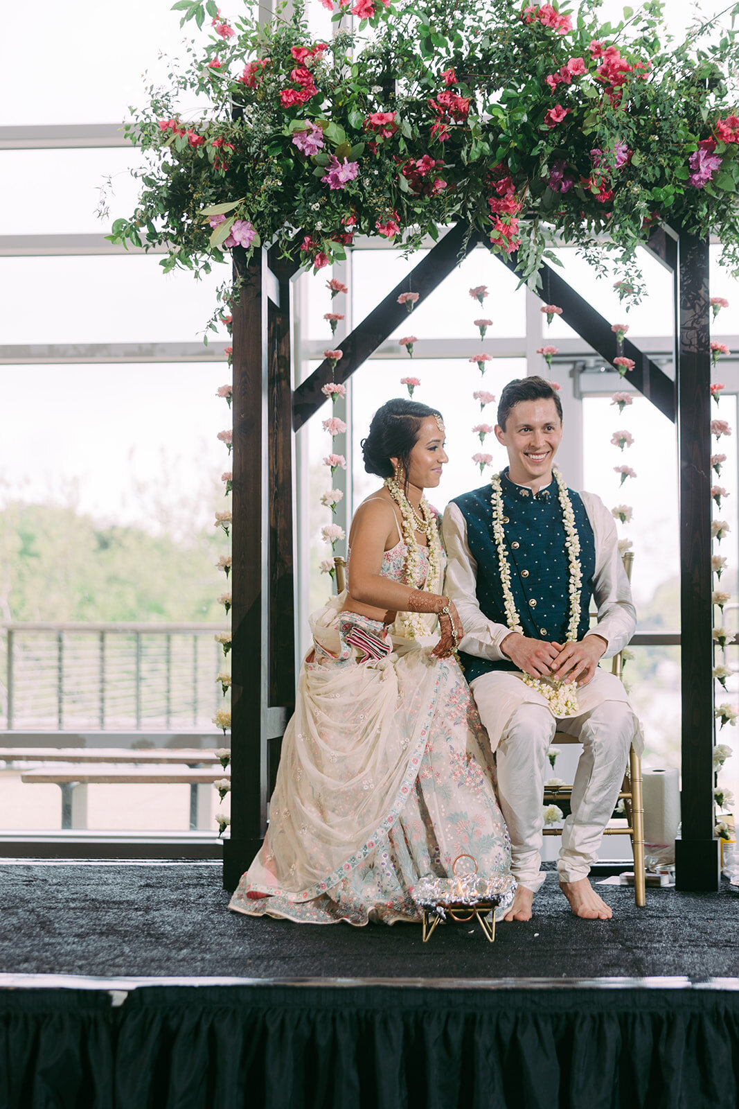 Unique ceremony arches. Artistic floral design with hanging pink carnations. Wedding florist serving waterfront wedding venues in Maryland.