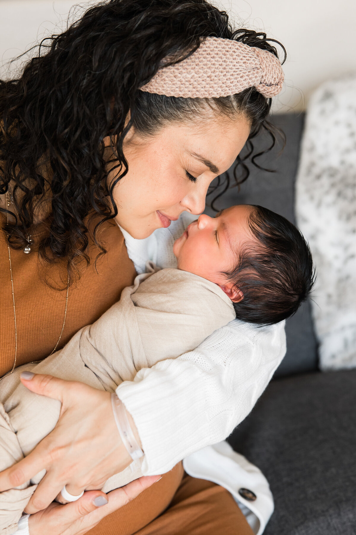 mom holding newborn baby in lifestyle Phoenix photography session