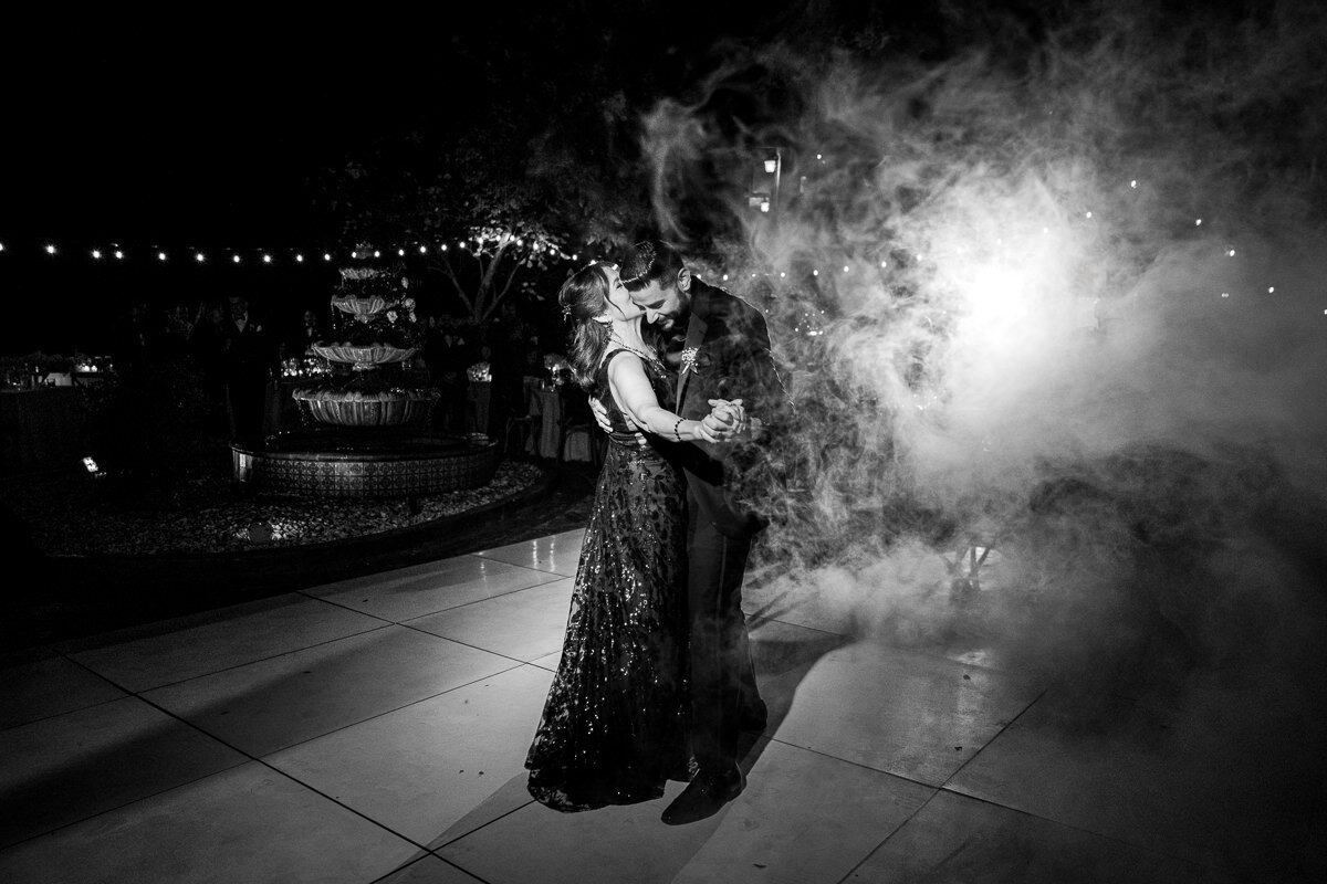 A touching moment as the groom dances with his mother under the romantic ambiance of Airola Road Vineyards, surrounded by the beauty of Murphys, California.
