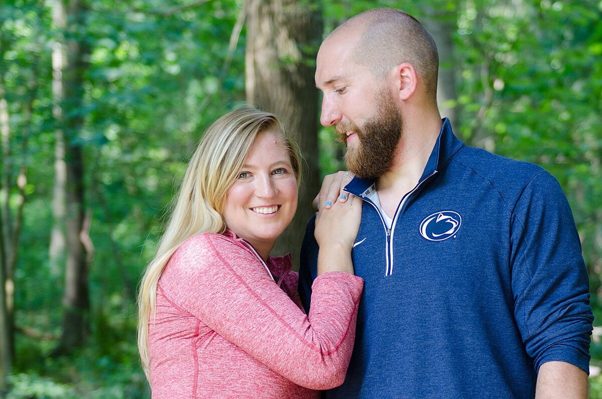 Penn State fan looks at his fiancée during their engagement session at Twin Lakes Park in Greensburg, PA