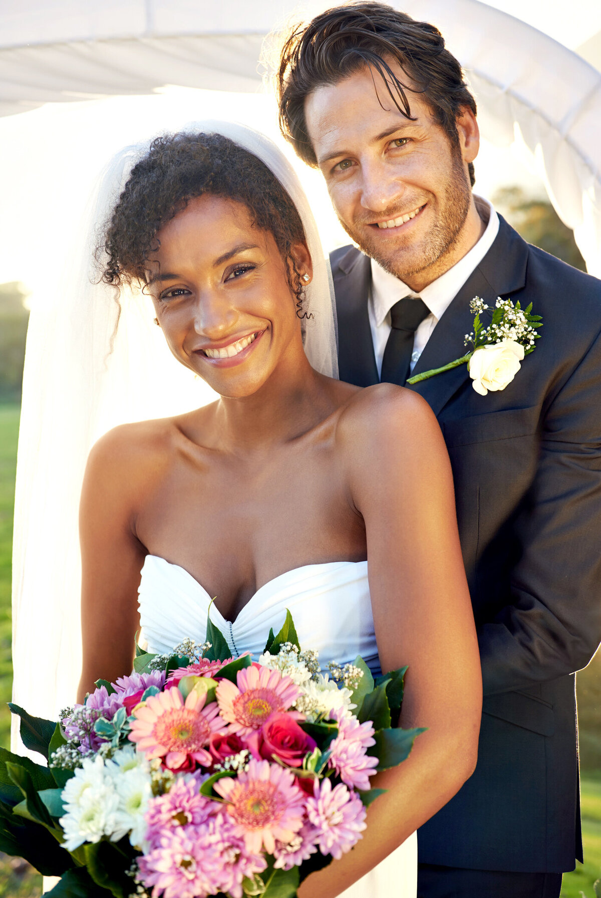 bride and groom holding a vibrant, colorful bouquet featuring lush florals, symbolizing love and cultural diversity on their wedding day