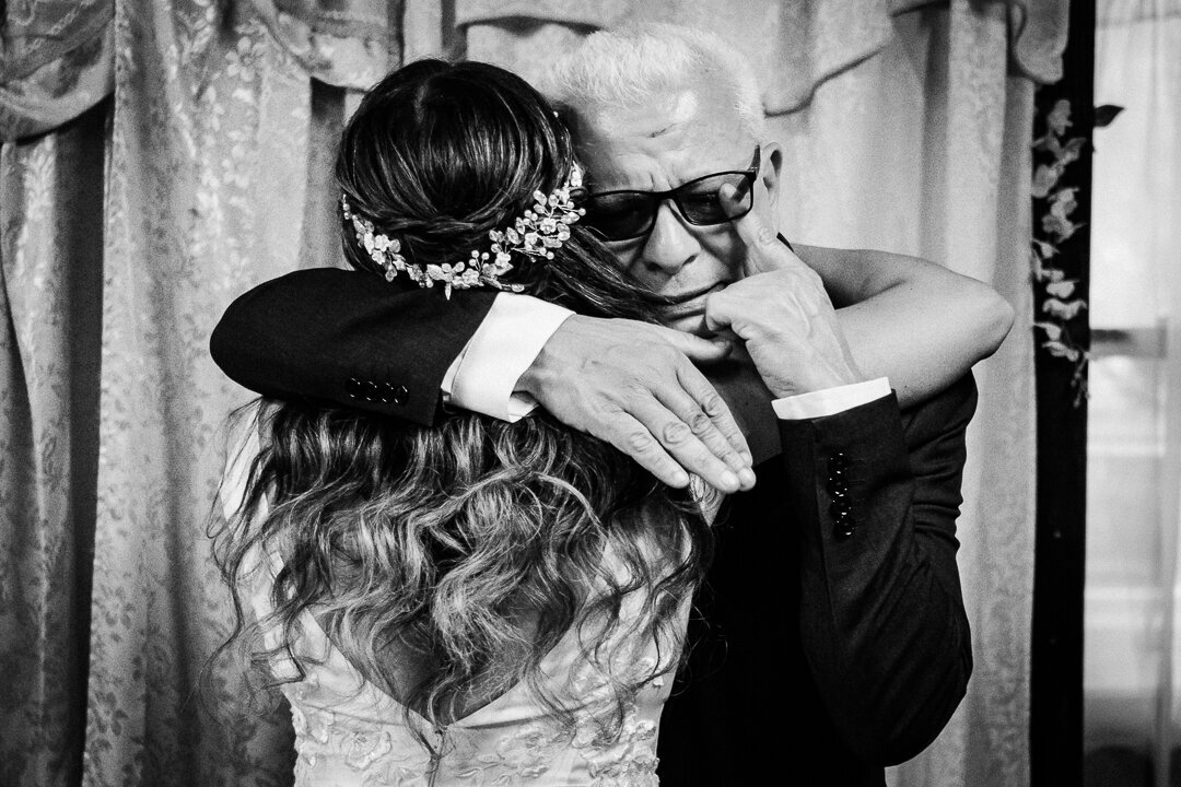 Bride shares an emotional tearful embrace with her father on her wedding day in New Jersey.