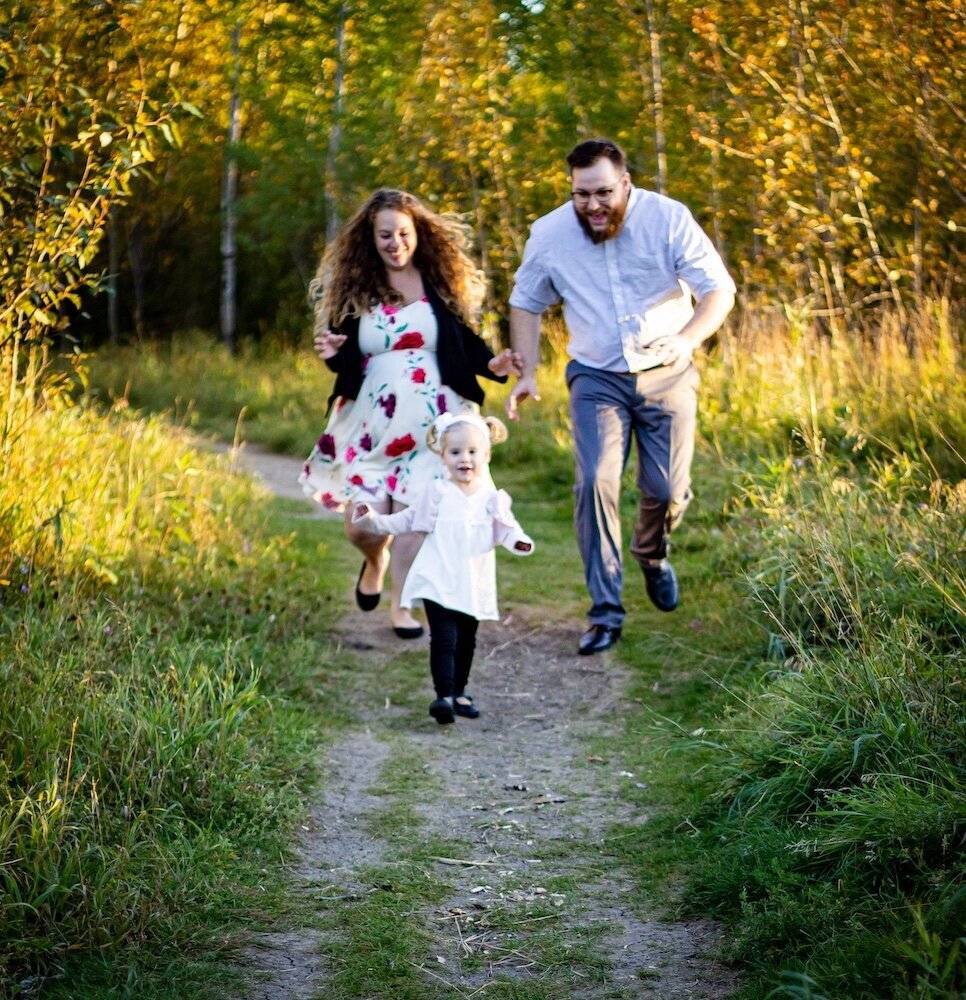 an Edmonton couple run after their toddler daughter down a dirt road 