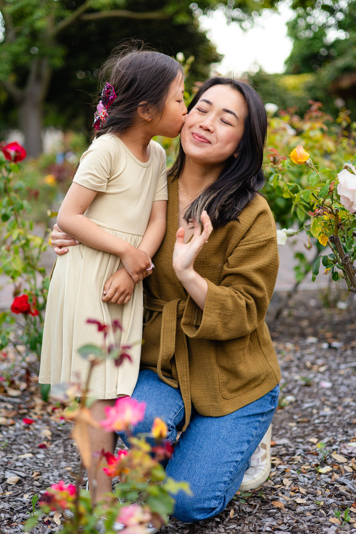 Daughter kisses her smiling mom in a colorful rose garden – Bay Area Family Portfolio - Ellobelle Photography Family Photographer