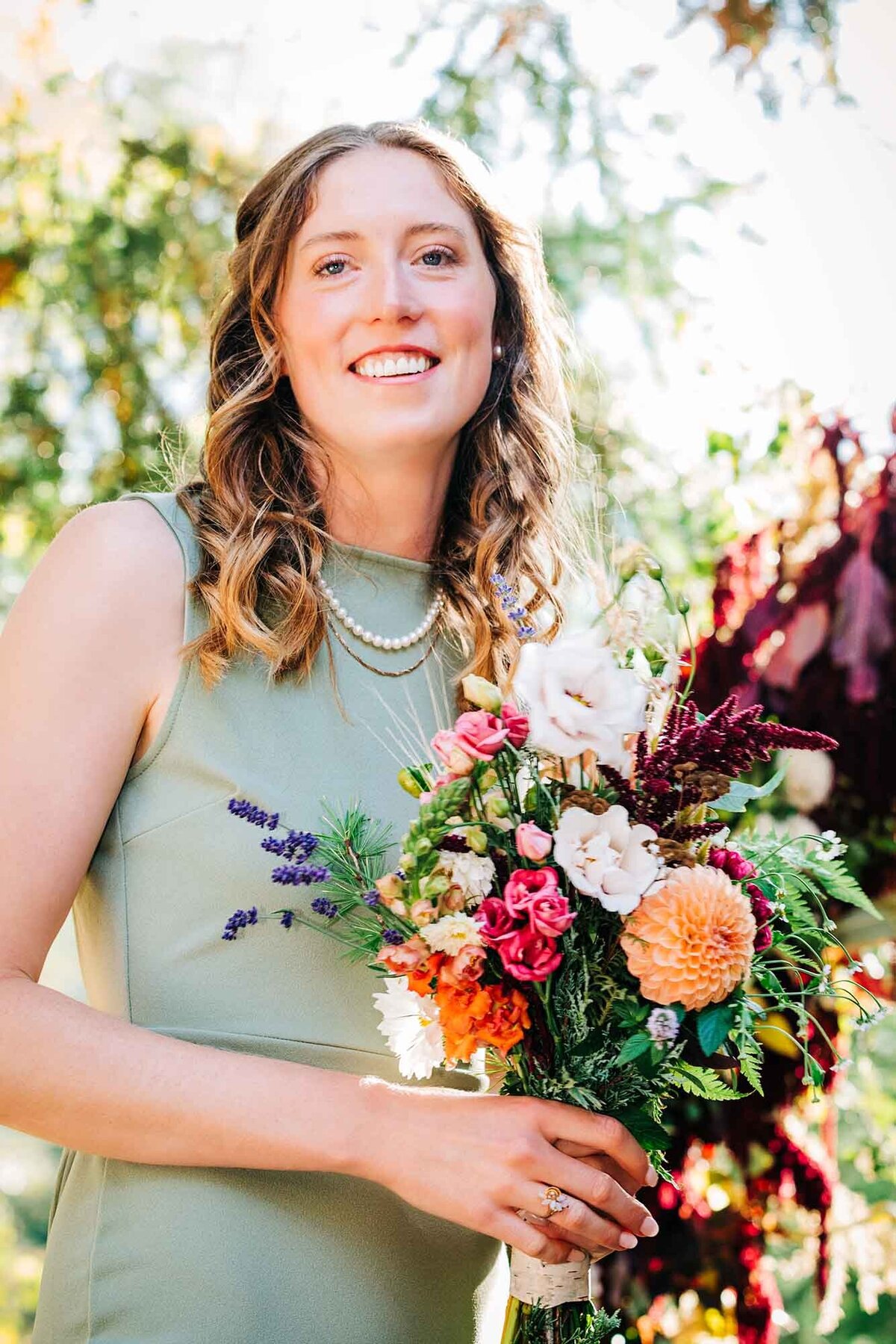 Maid of honor holding bridal bouquet at Izaak Walton Inn, Essex, MT