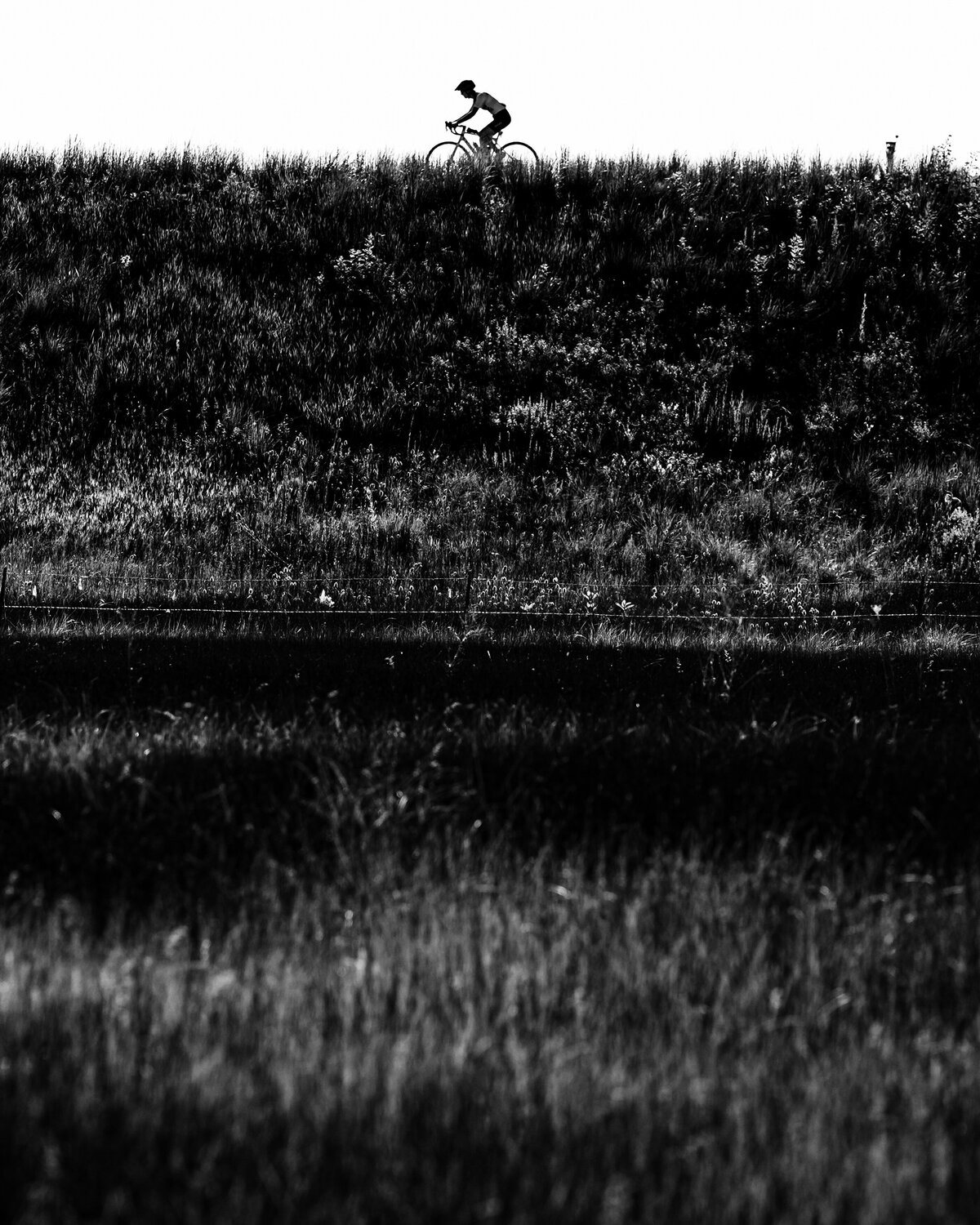 kansas-city-sports-photography-0166-silhouette-cyclist-riding-ontop-hill