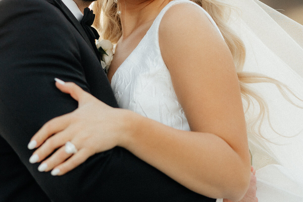 Details of the brides dress and ring.