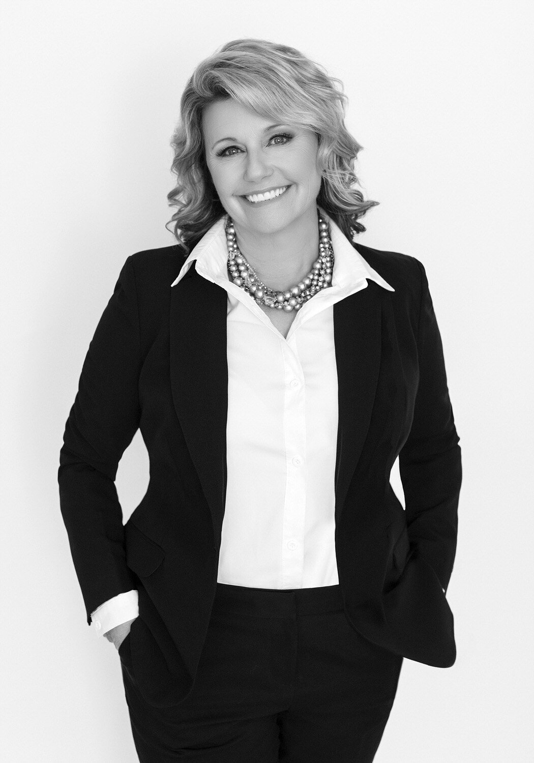 Black and white headshot of a woman realtor.