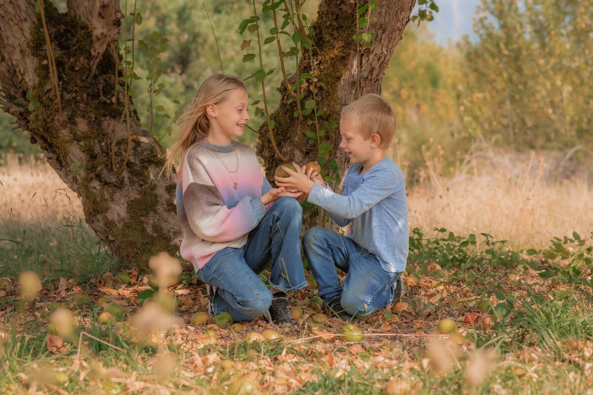 Kids playing in an apple orchard in Camas, Washington