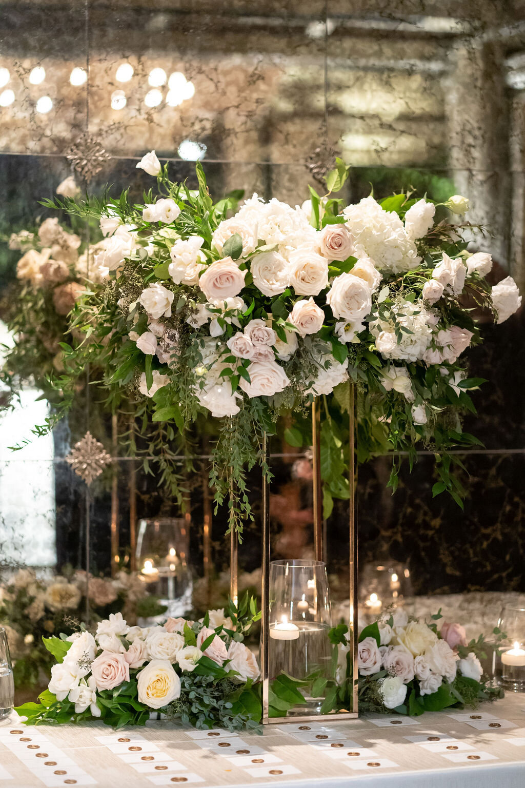 tall escort card centerpiece with candles