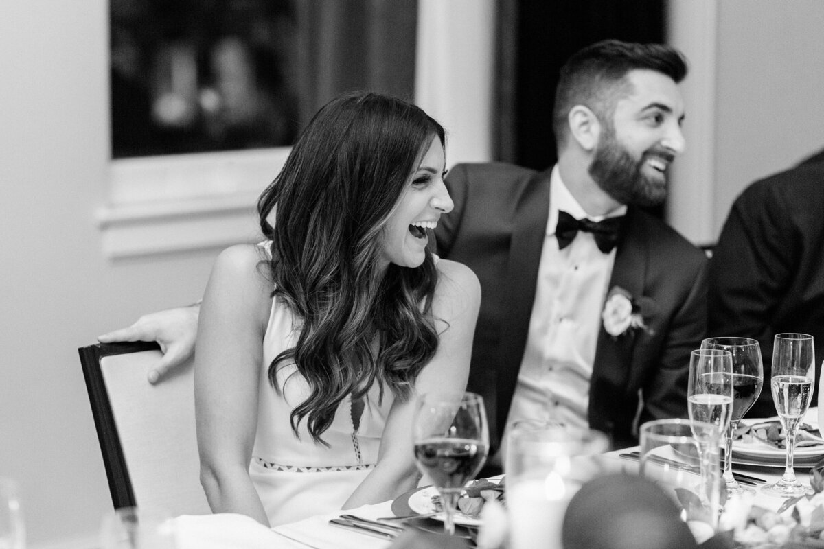 Couple laughing at their wedding dinner