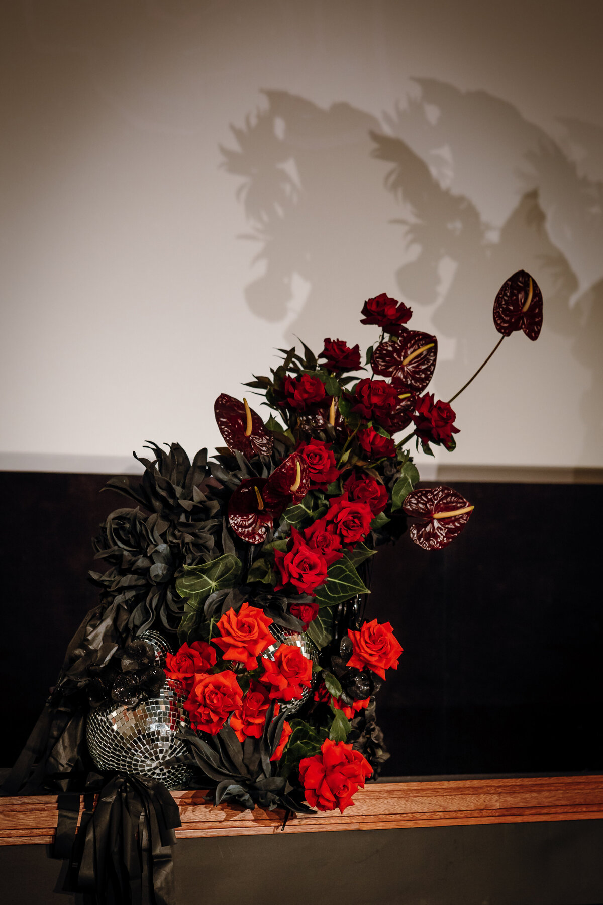 Close up shot of the red floral arrangement on stage.