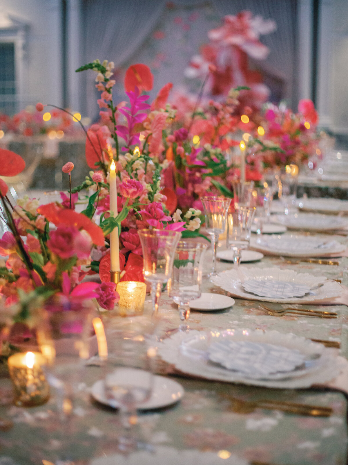 A breathtaking whimsical wedding tablescape featuring gold chairs, lush floral arrangements, and an enchanting design. The combination of elegant table settings, delicate candlelight, and intricate details creates a dreamy and romantic atmosphere, perfect for couples seeking a fairytale-inspired wedding aesthetic.