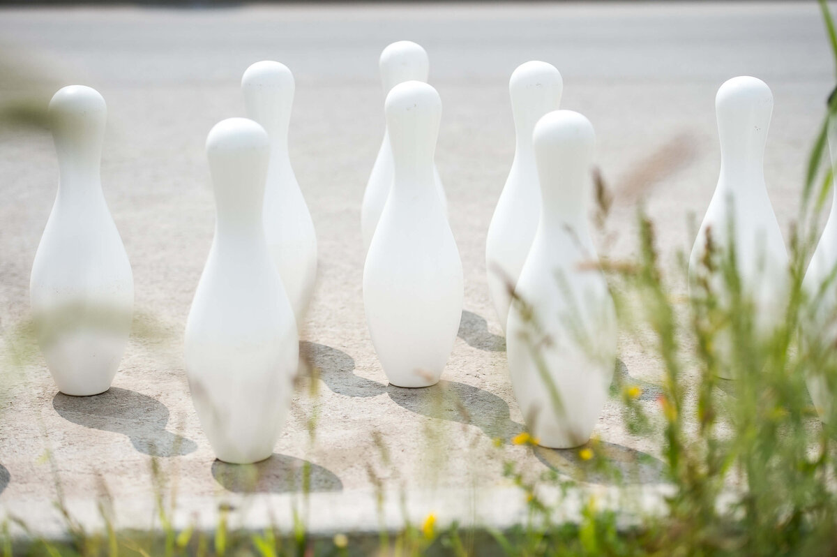 Ottawa event photography showing the setup of a bowling activity with white bowling pins and red ball as part of a corporate children's event.  Captured by JEMMAN Photography COMMERCIAL