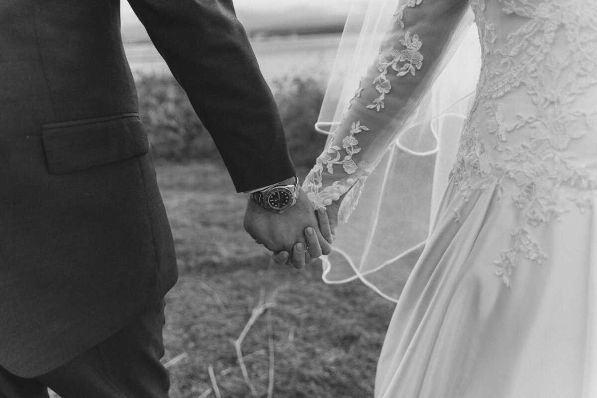 Vintage hand holding photo of bride and groom
