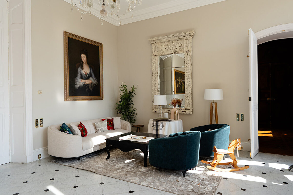 Elegant interior room with French furniture, artwork, and natural light inside Château de Tourreau.