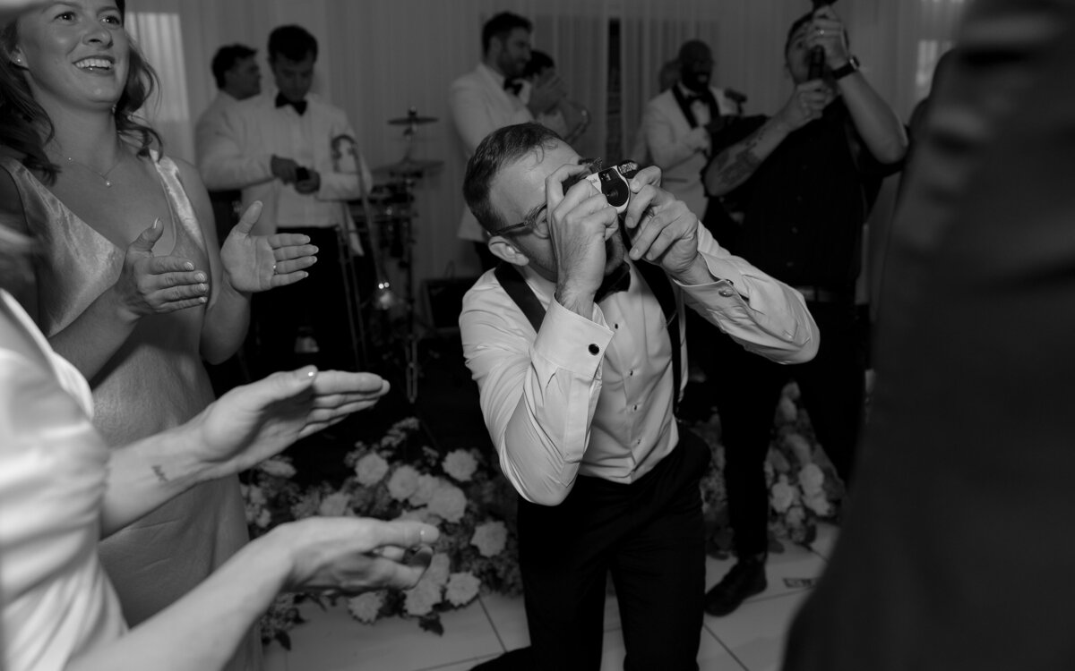 Wedding guest snaps photos on the dancefloor at Belle Mer in Newport.