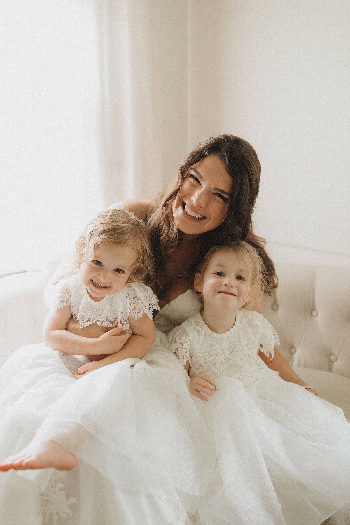 bride sits with her two daughters