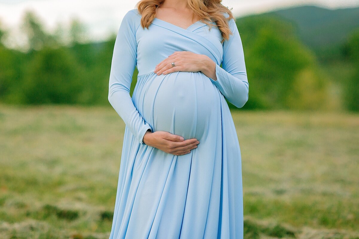 Mom to be wearing blue gown