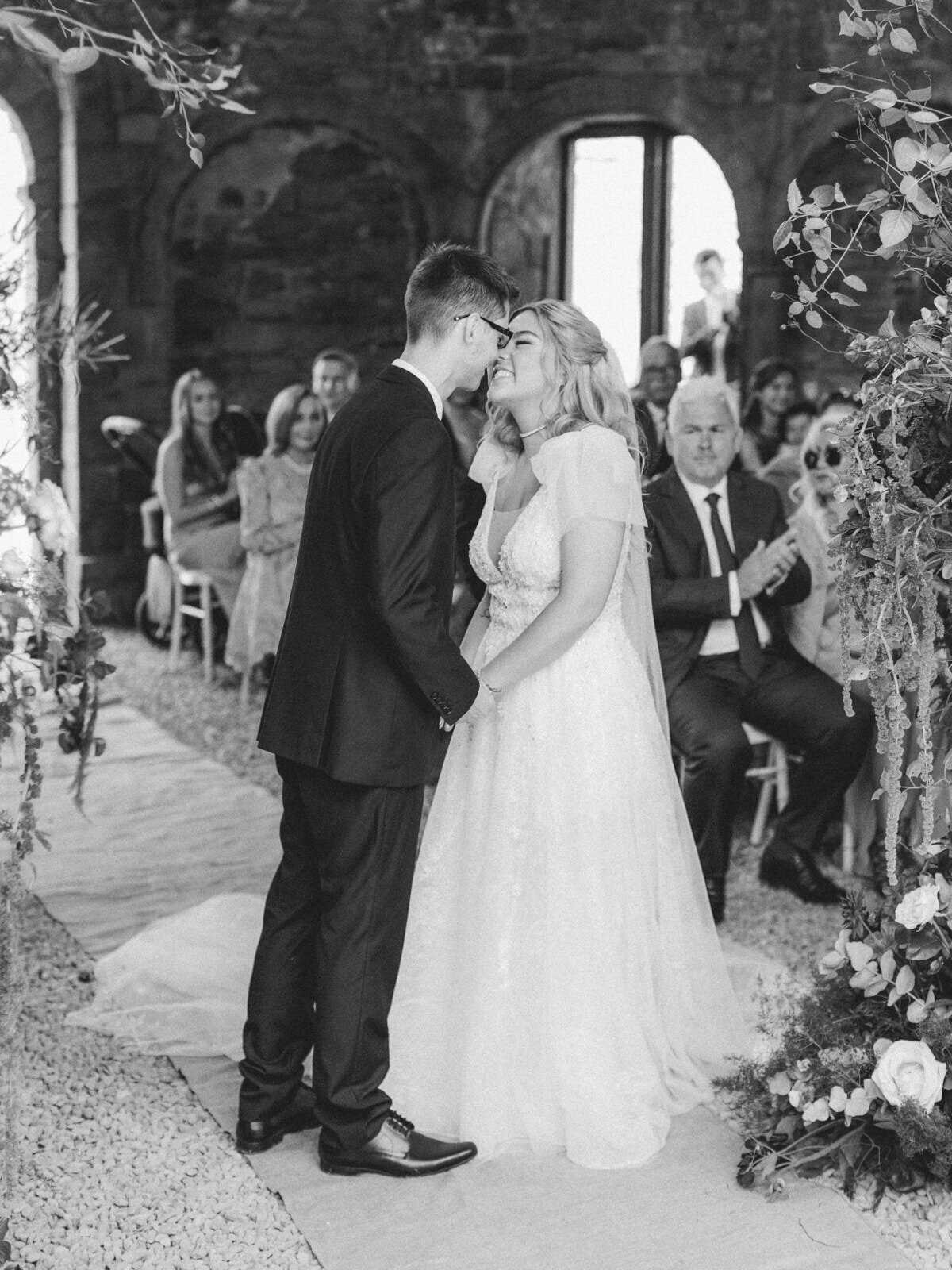 bride and groom first kiss at ludlow castle wedding in shropshire