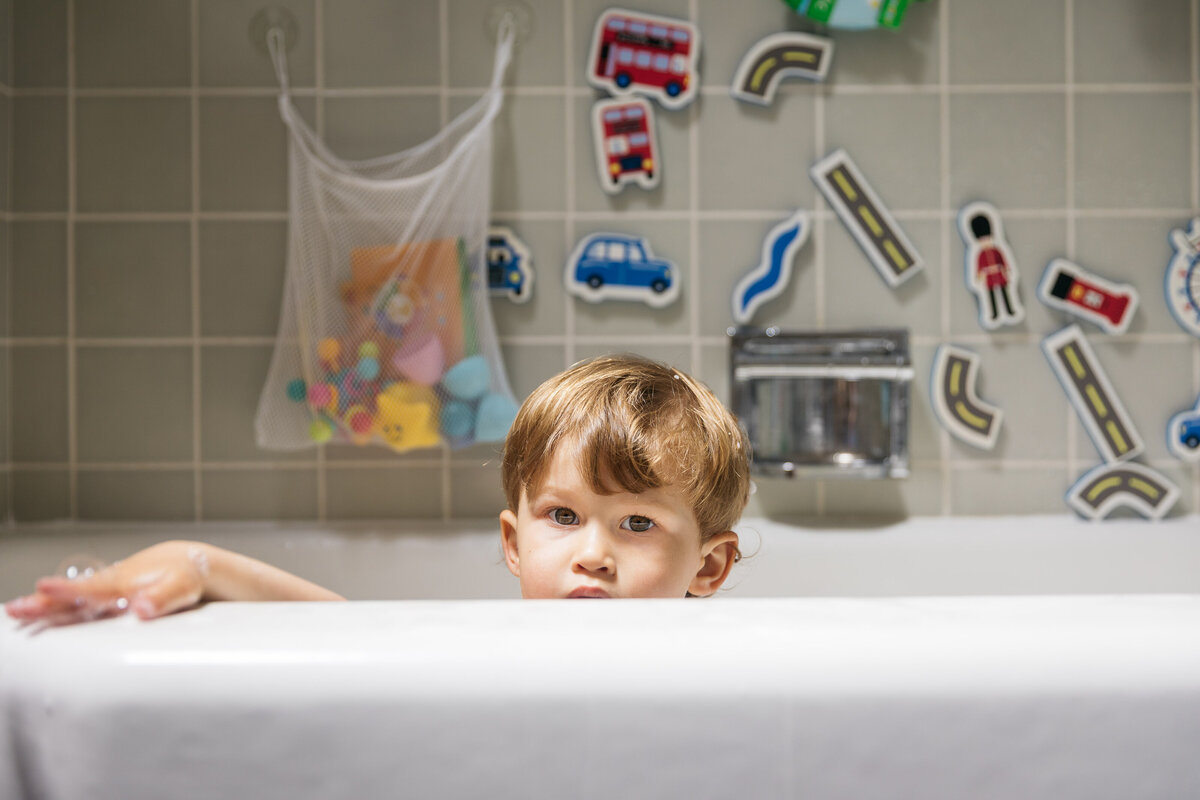 Toddler is enjoying a bath. 