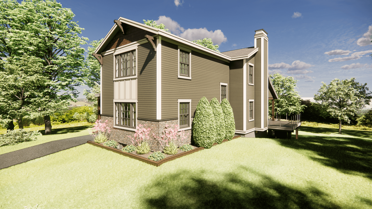 A modern two-story house with brown siding and white trim, surrounded by lush green grass and trees. Pink flowers line a garden bed along the house. A wooden deck extends from the side, under a clear blue sky with scattered clouds.