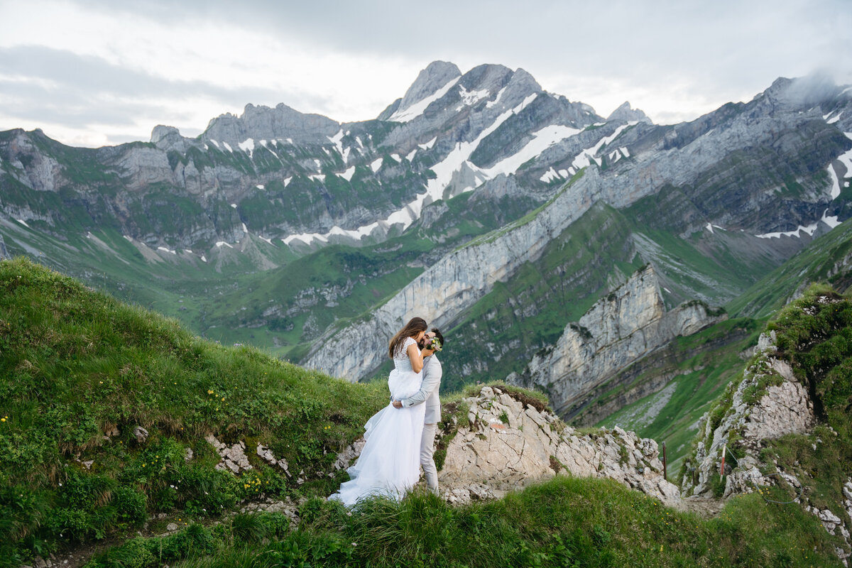 Groom lifting bride for kiss in Appenzell Switzerland