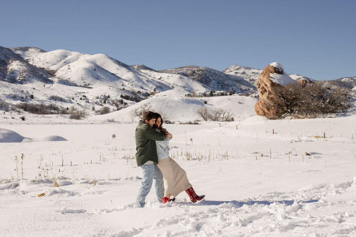 couple playing in swoy field
