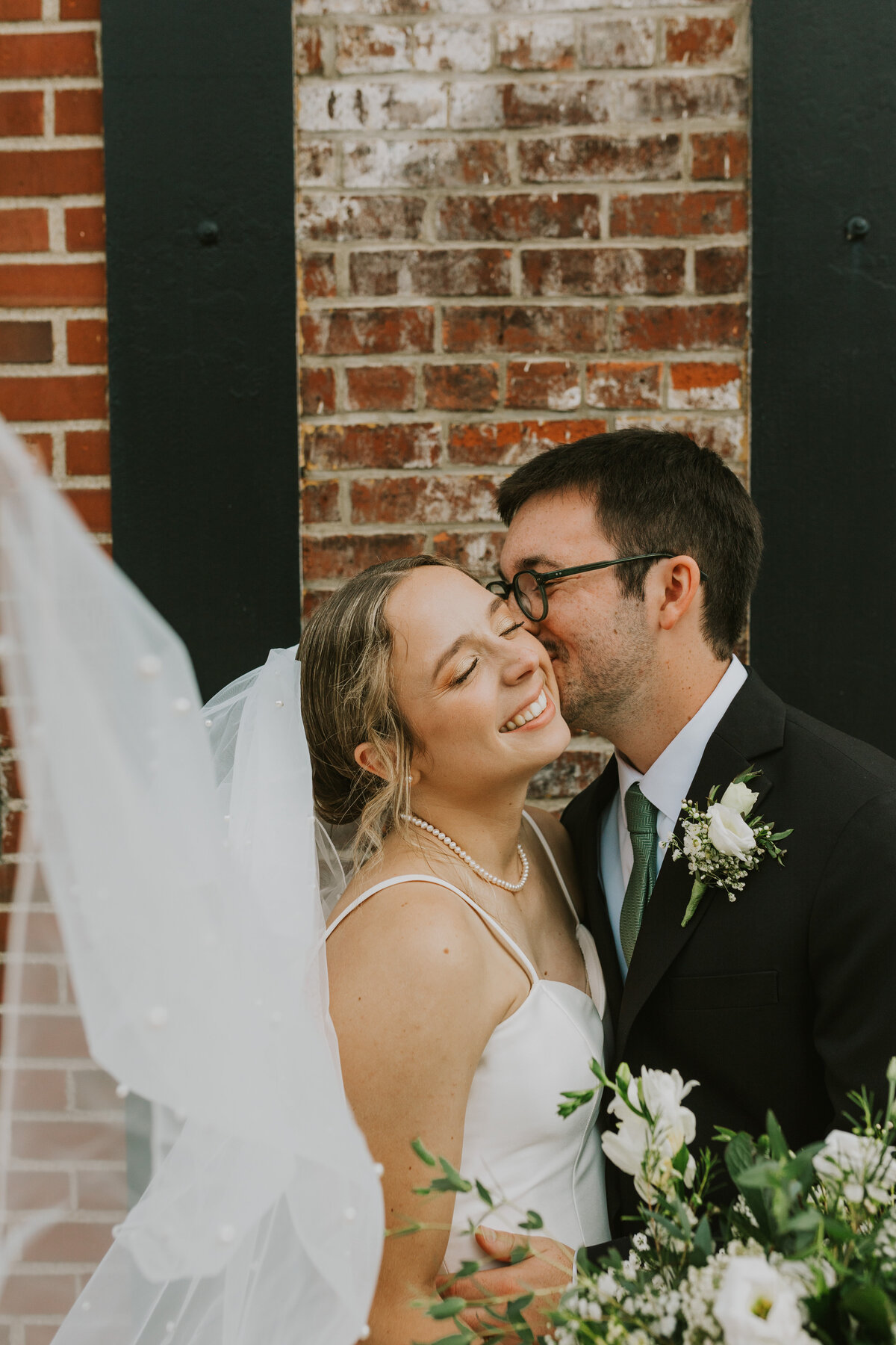 Bride and groom in a close embrace, Indiana wedding love story.