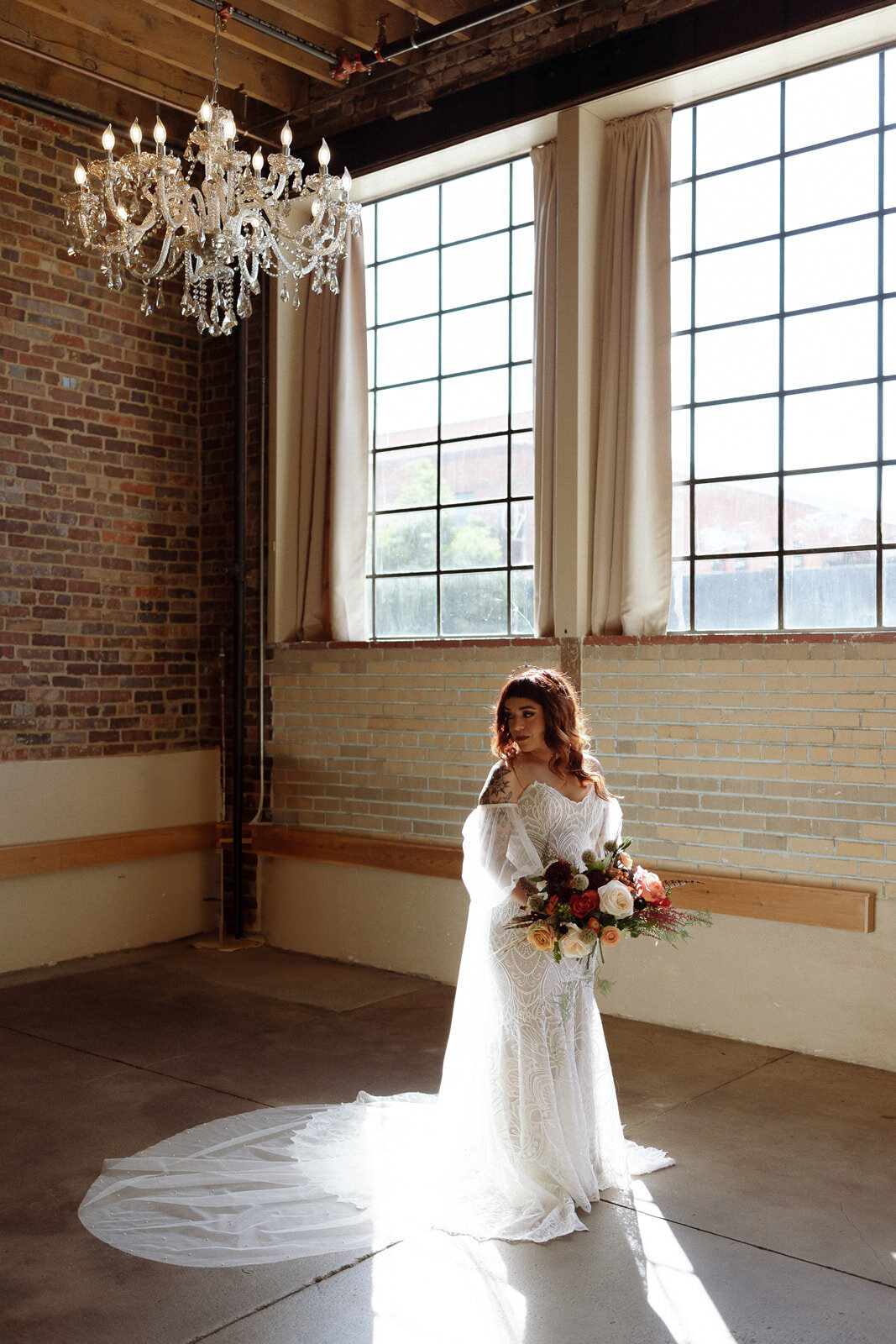 Bride poses before her wedding ceremony with a fall colored bouquet at Upper Larimer in Denver Colorado.