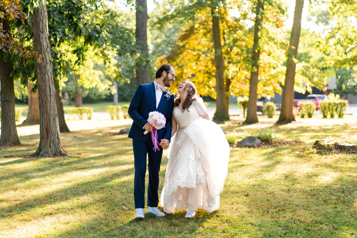 Bride and groom walking outside of the Akron Woman's City Club in Akron, Ohio.