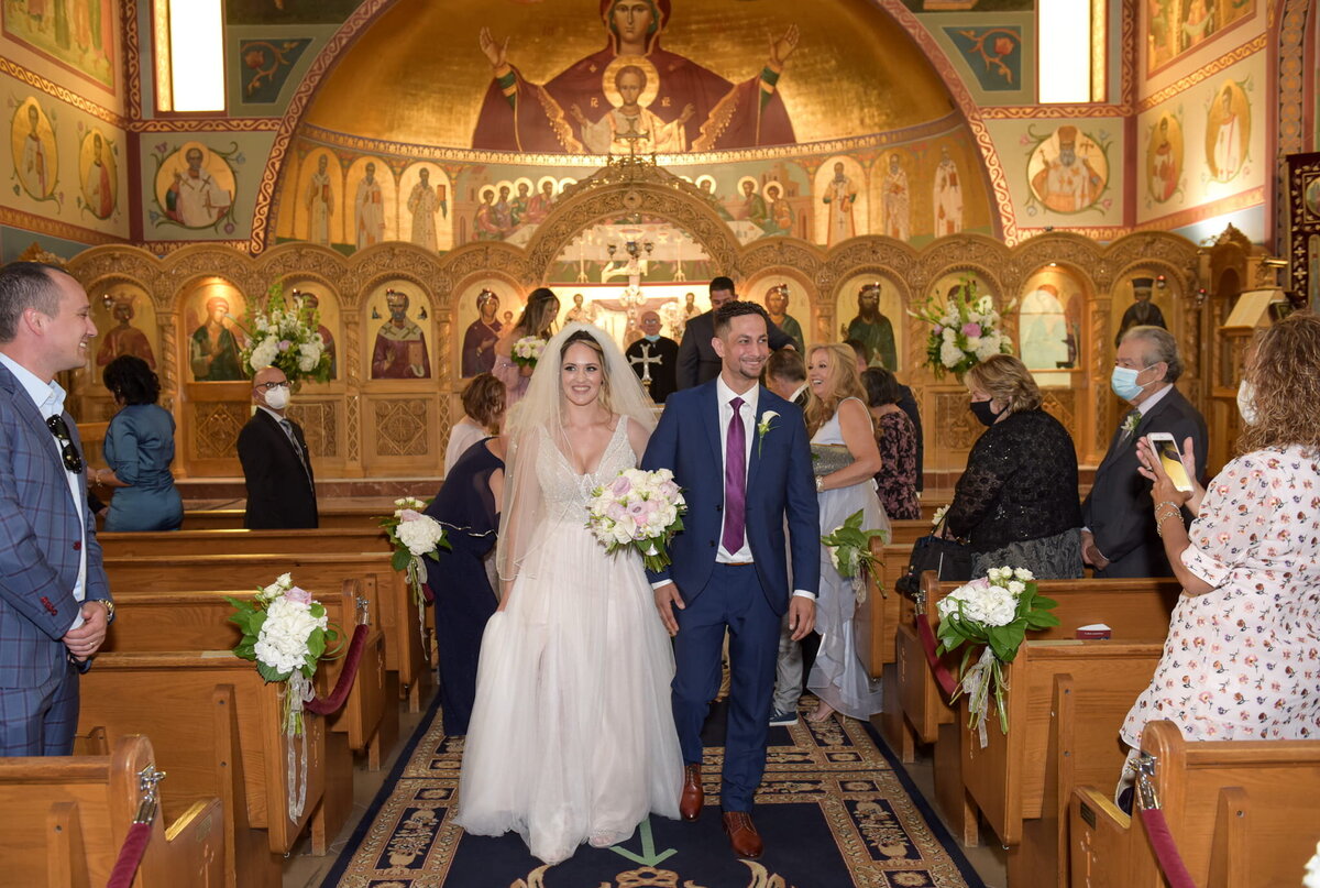 Bride and groom in front of church altar