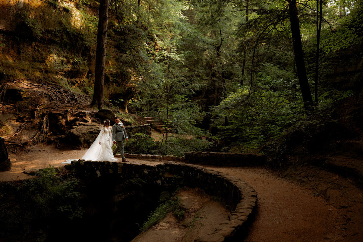 Bride and Groom walk at Old Mans cave after eloping