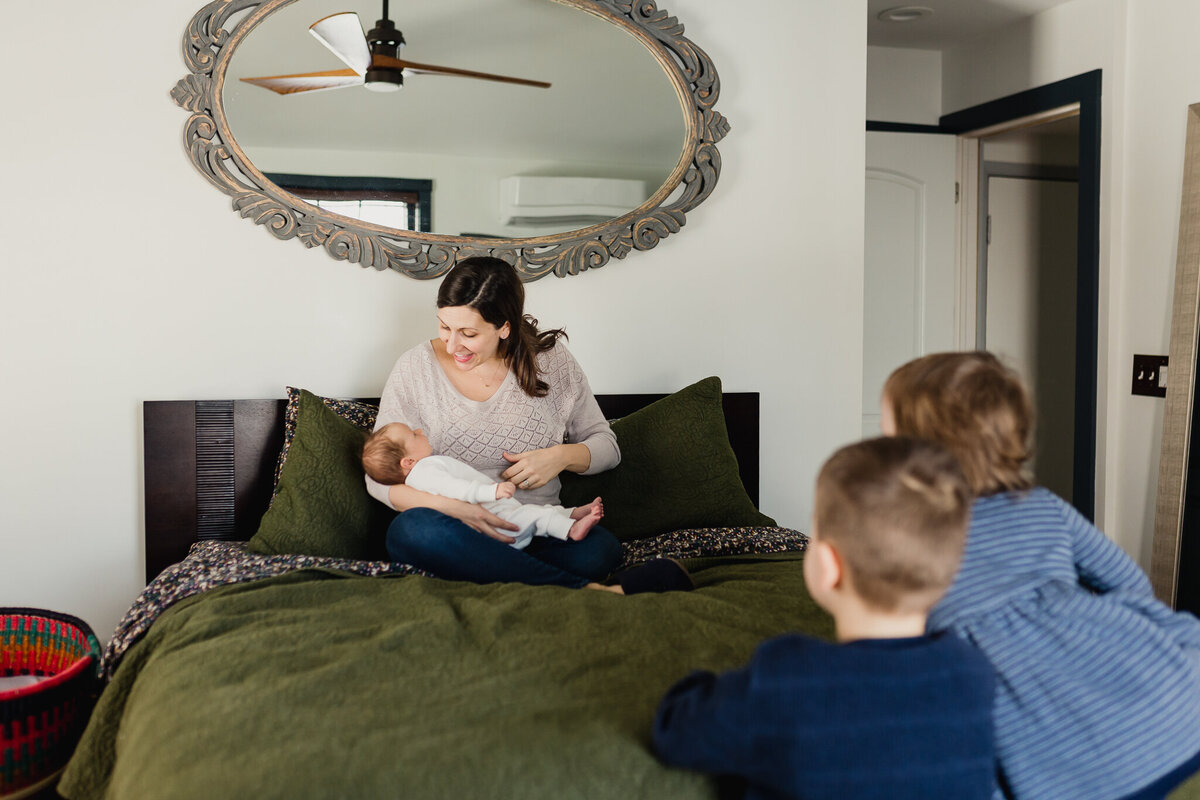 Infant photography of a mom holding new born baby