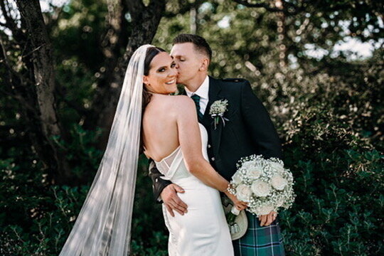 Bride and groom posing for wedding pictures