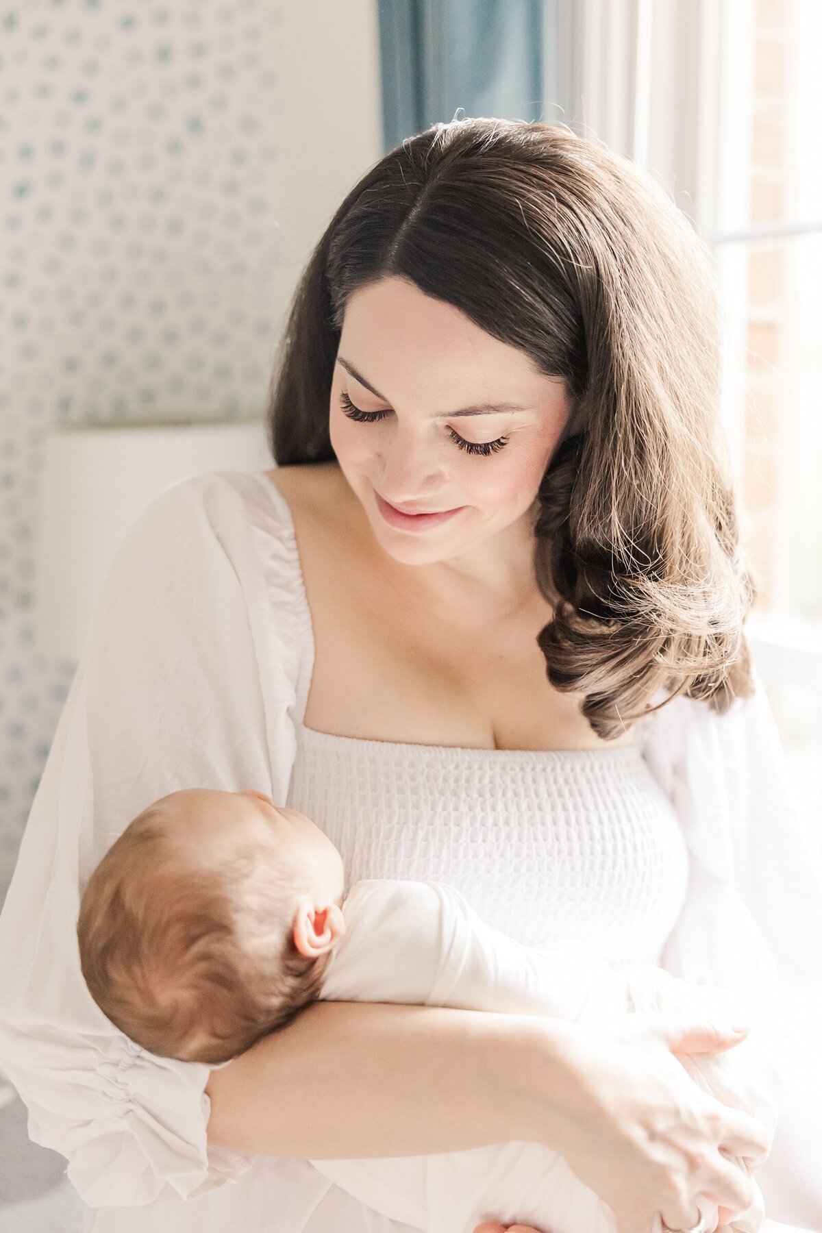 New mom looking down at her beautiful baby boy