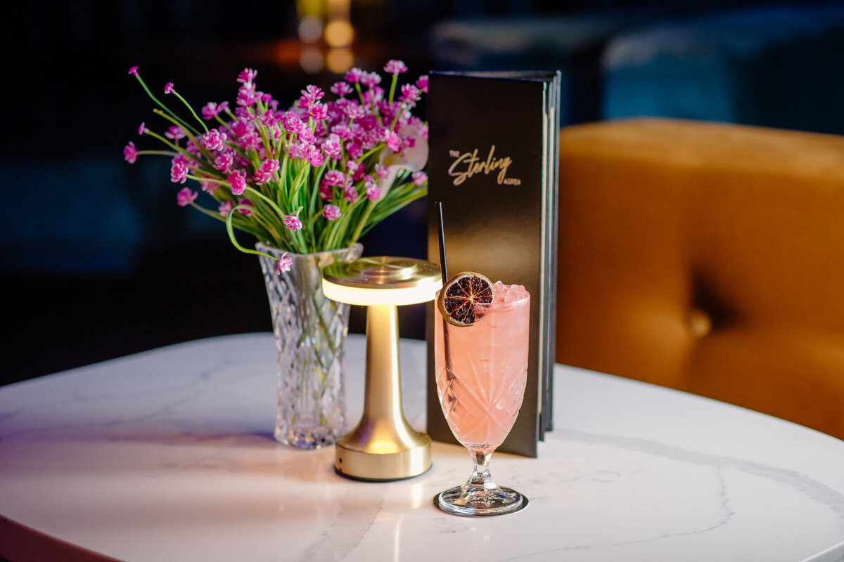 A cocktail is displayed on a quartz table in Aspen, Colorado.