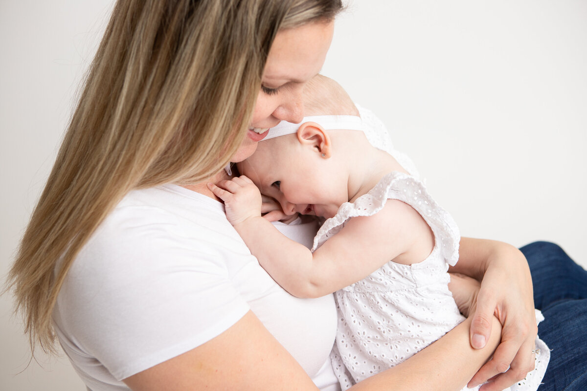 Mom and son on a simple white savage backdrop