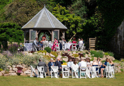 Wedding guests sitting around the summerhouse