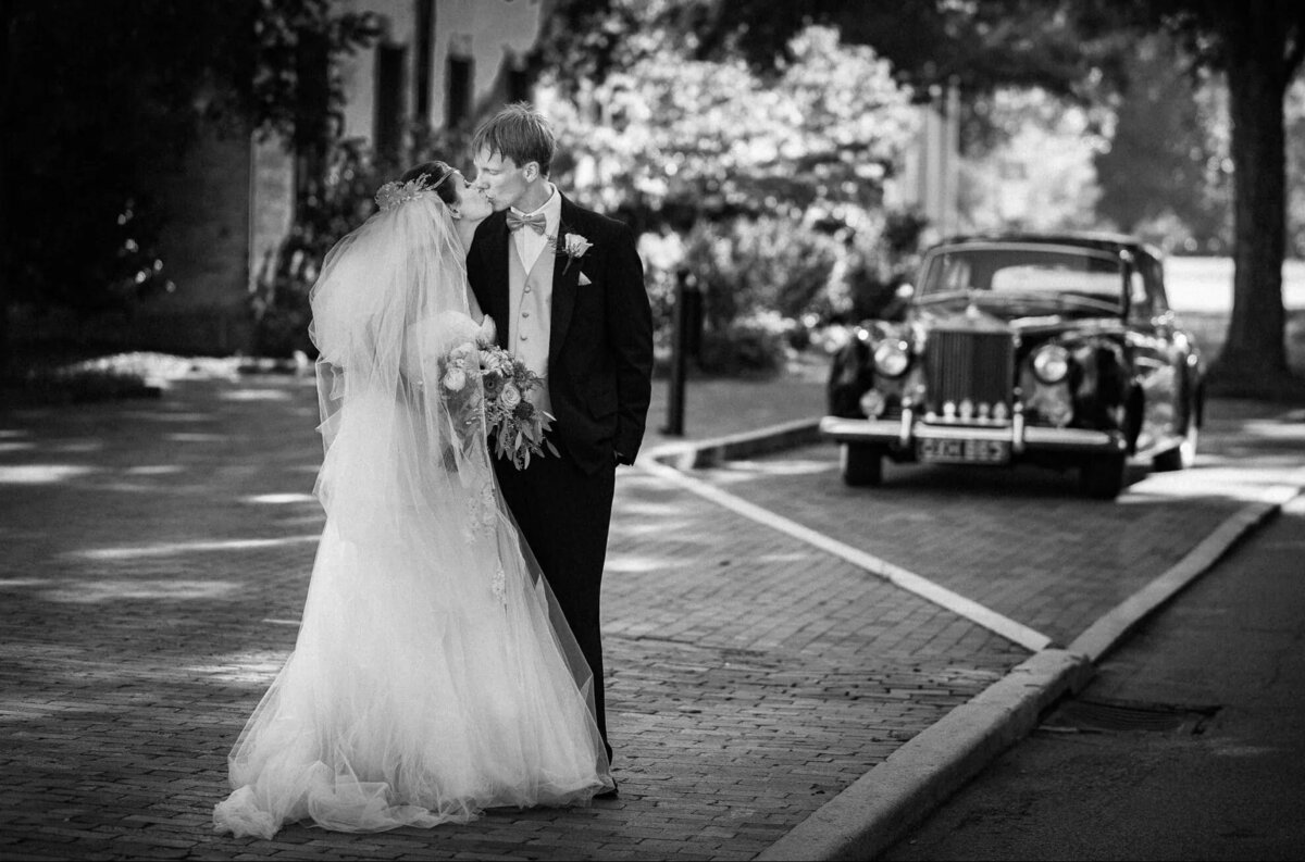 A newlywed couple shares a private moment on a city street