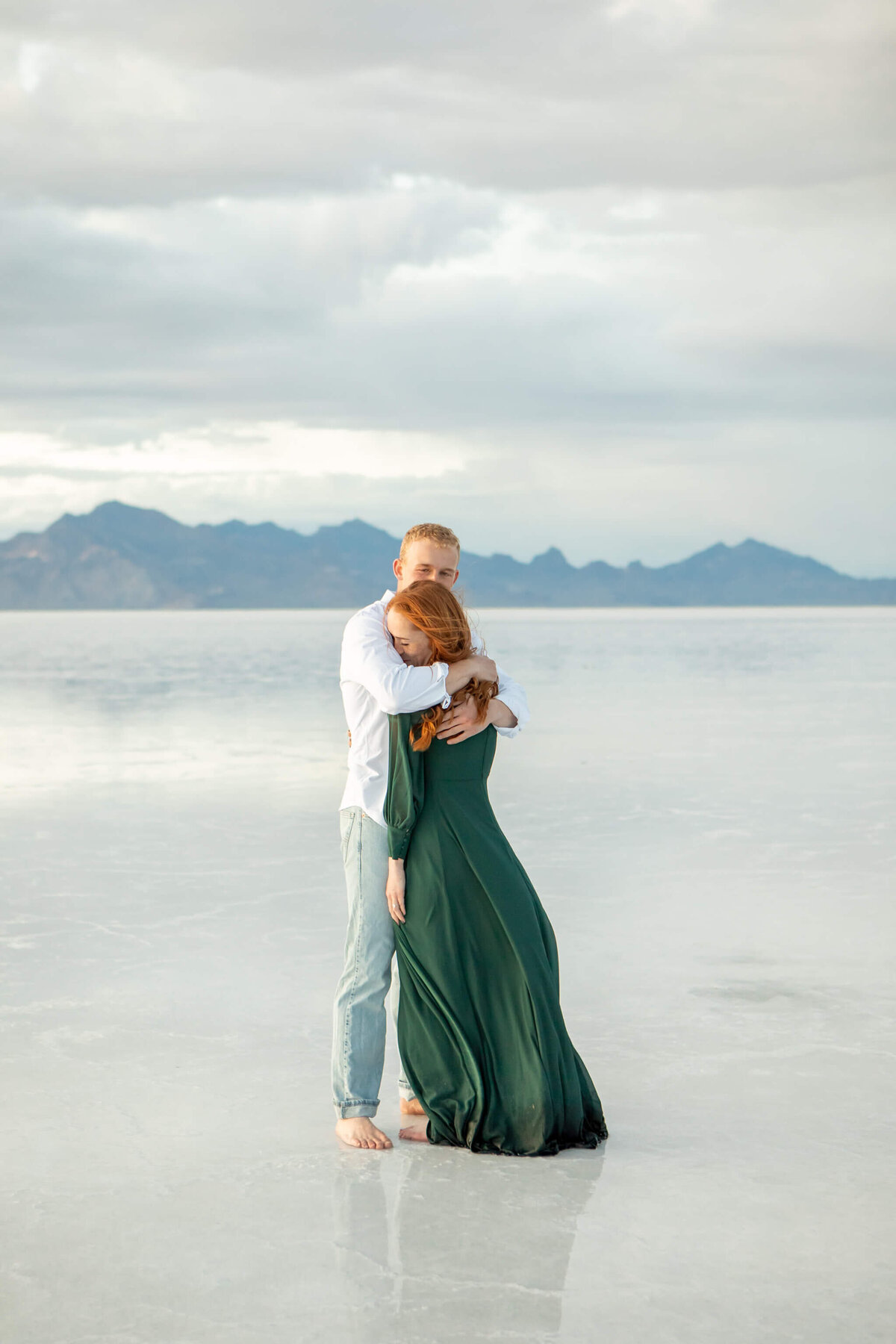 A man in white shirt hugs his fiance at the Bonneville salt flats in UT